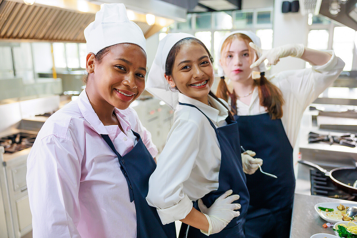 Group portrait young wman cooking student. Cooking class. culinary classroom. group of happy young woman multi - ethnic students are focusing on cooking lessons in a cooking school.